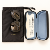 Lentes Gucci con-estuche; foto retocada con IA.